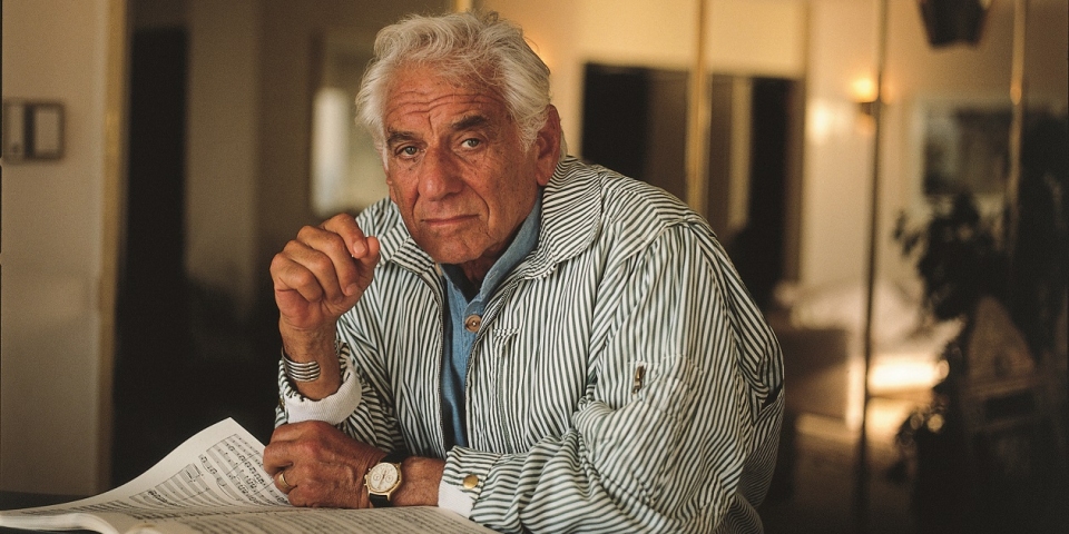 The composer Leonard Bernstein wearing a stripped shirt